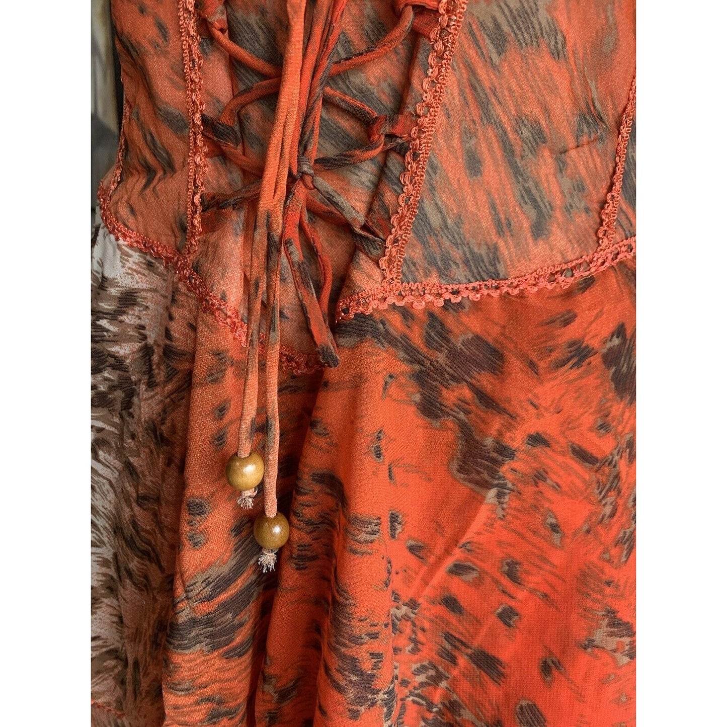Closeup Of Beads And Trim On Orange Abstract Animal Print Corset Handkerchief Dress