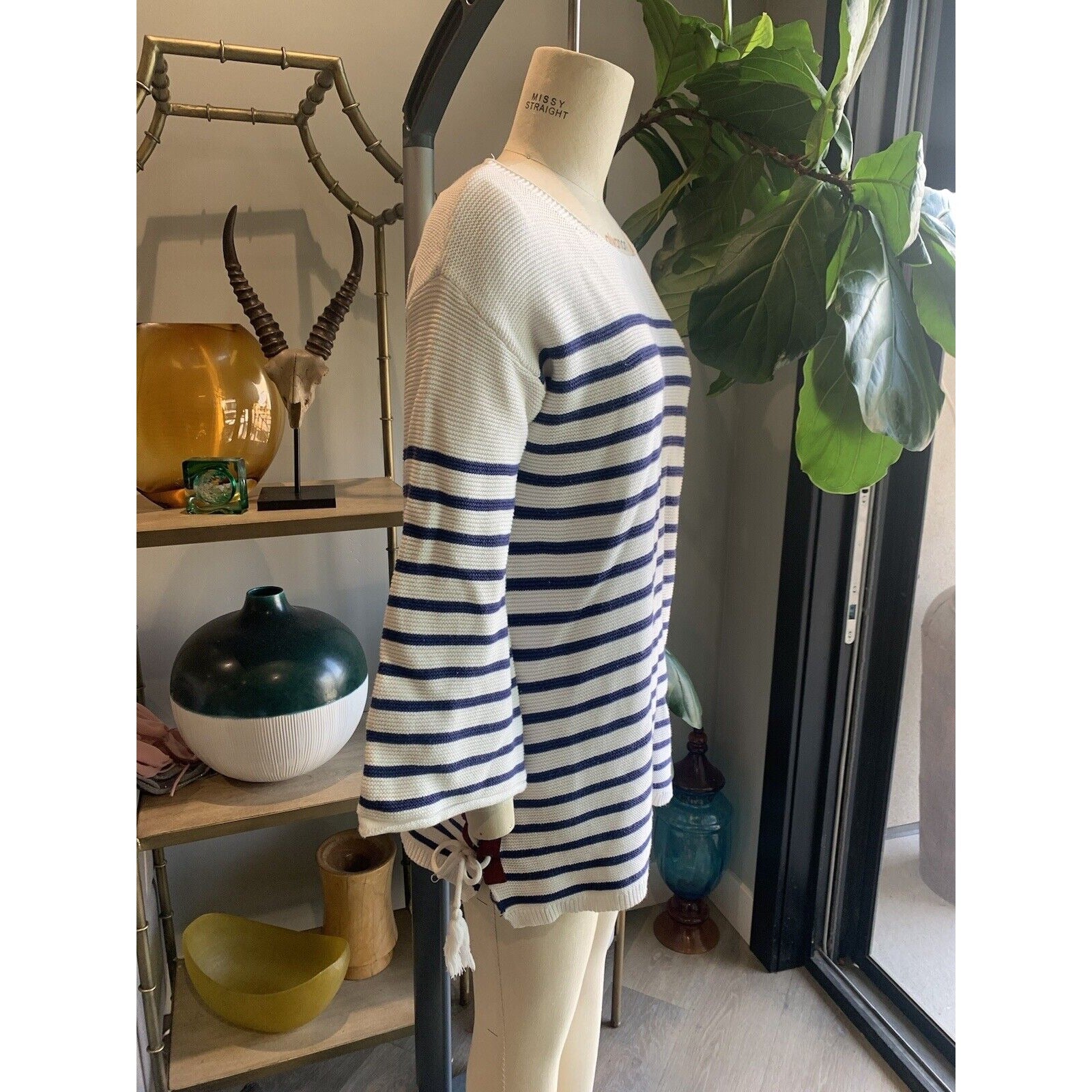Side View Of Women's Blue And White Striped Sweater