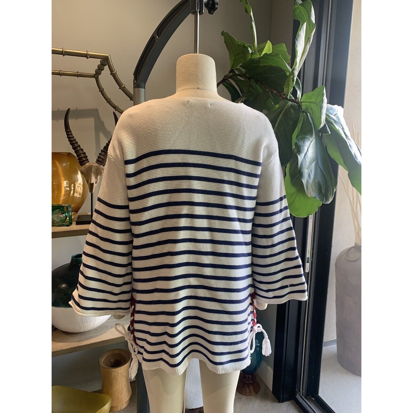 Rear View Of Women's Blue And White Striped Sweater