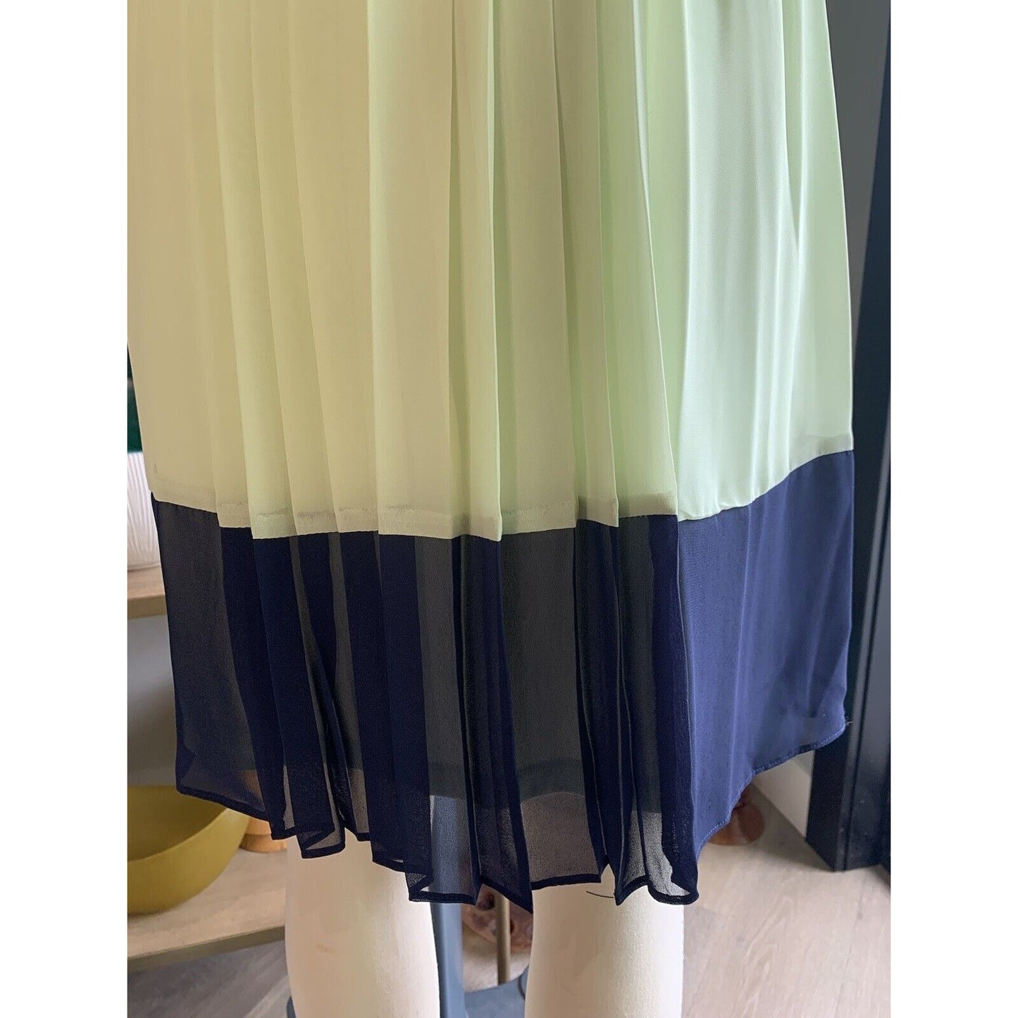 Closeup Of Pleated And Color-Blocked Sleeveless Dress