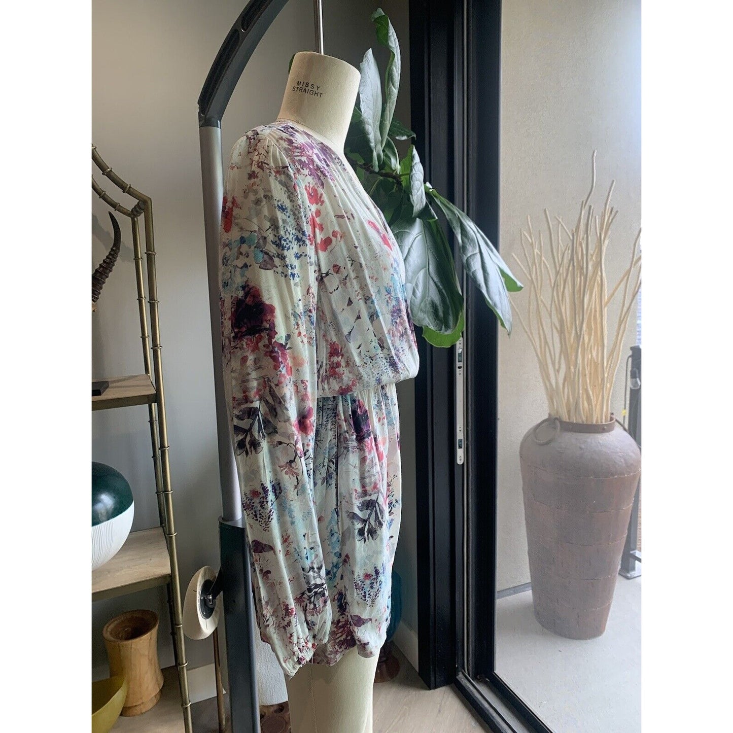 Side View Of Floral Blouson Long Sleeve Romper