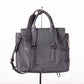 Back of 3.1 Phillip Lim Leather Pashli Medium Handbag Satchel In Gray Displayed on a Stand and White Background