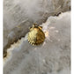 1 Gold-Tone Seashell Charm On Gray Marble-Like Background