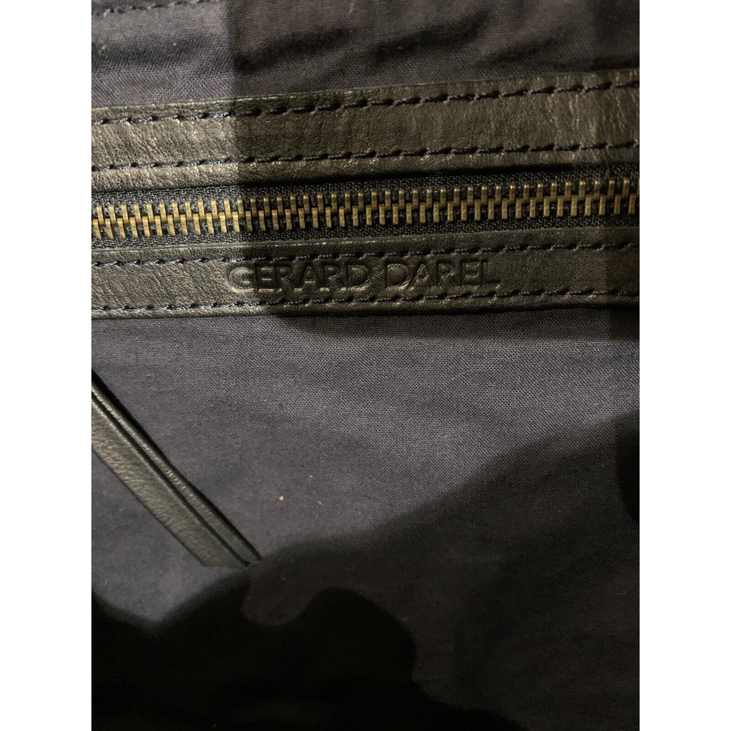 Closeup Of Handbag Zipper And Branding