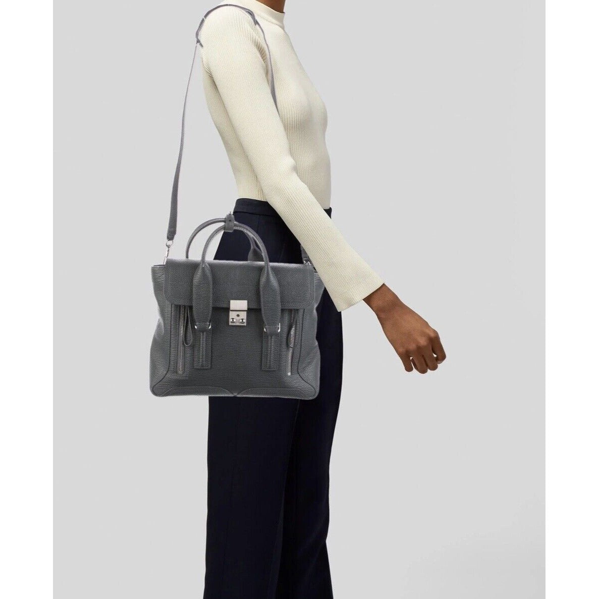 3.1 Phillip Lim Leather Pashli Medium Handbag Satchel In Gray Hanging on the Shoulder of a Woman on a White Background