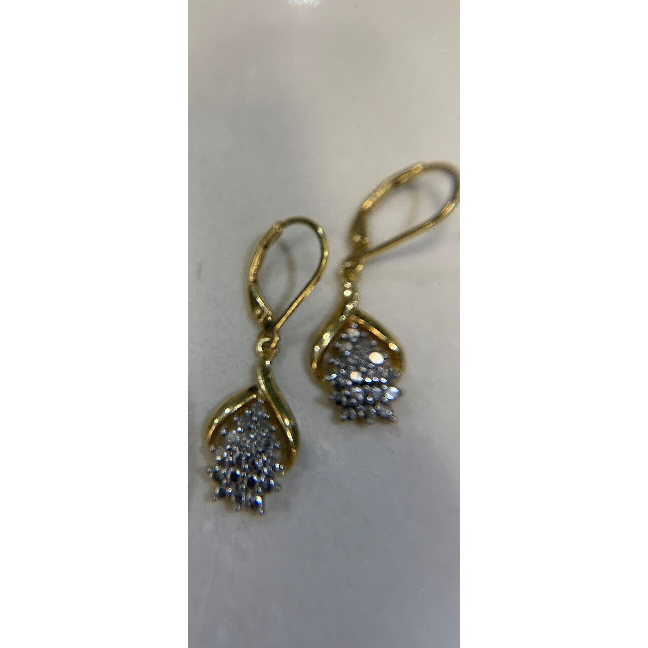 18 Karat Gold Over Sterling Silver Diamond Accent Cluster Earrings On Gray Background
