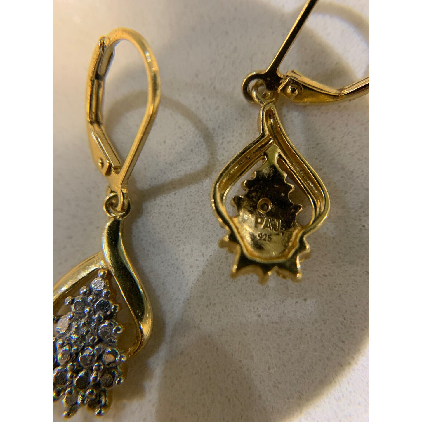 18 Karat Gold Over Sterling Silver Diamond Accent Cluster Earrings With The Back Of One Earring Showing The Stamp On Gray Background