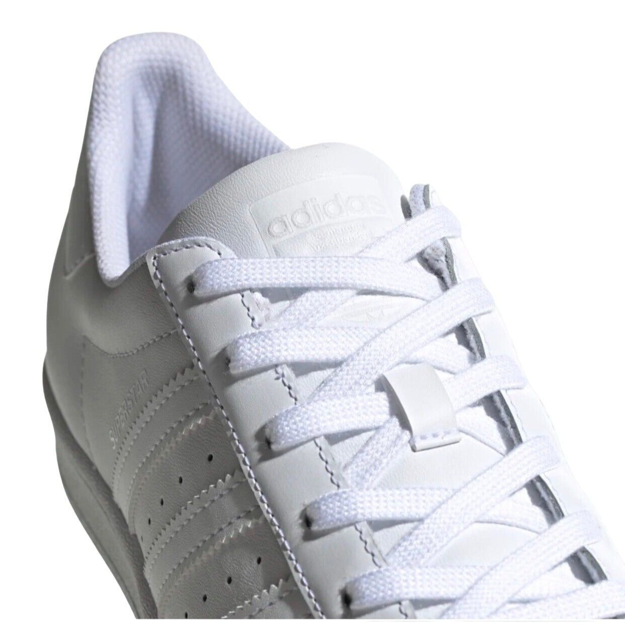 closeup view of laced up white Adidas sneaker
